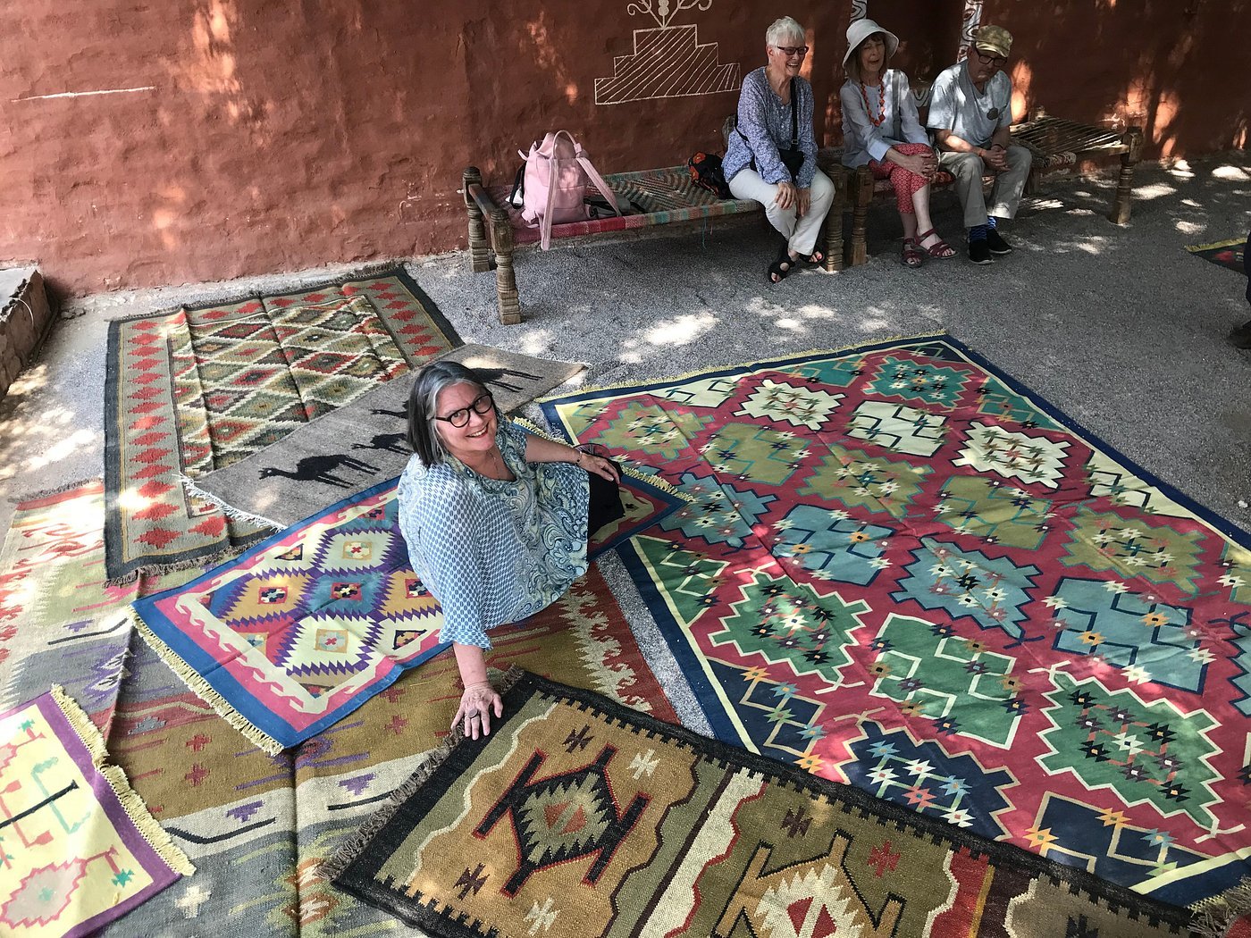 Guests enjoying a traditional cultural activity seated on a rug